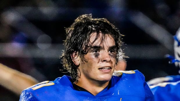Mukwonago High School running back Wynn Stang standing on the sidelines.